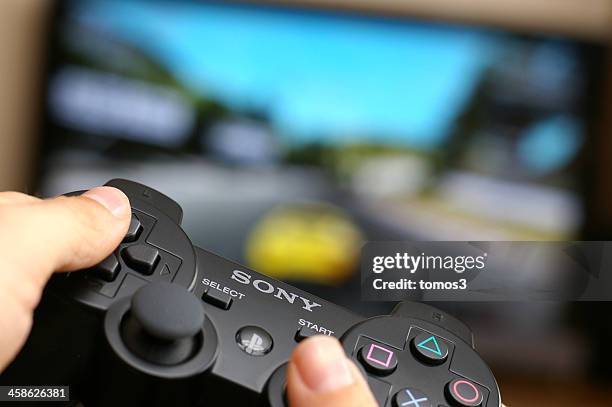 gaming on playstation 3 - gaming controller stock pictures, royalty-free photos & images