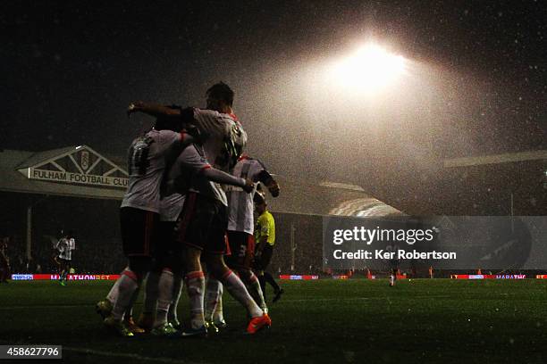 Lasse Vigen Christensen of Fulham is surrounded by team mates after scoring his teams second goal during the Sky Bet Championship match between...