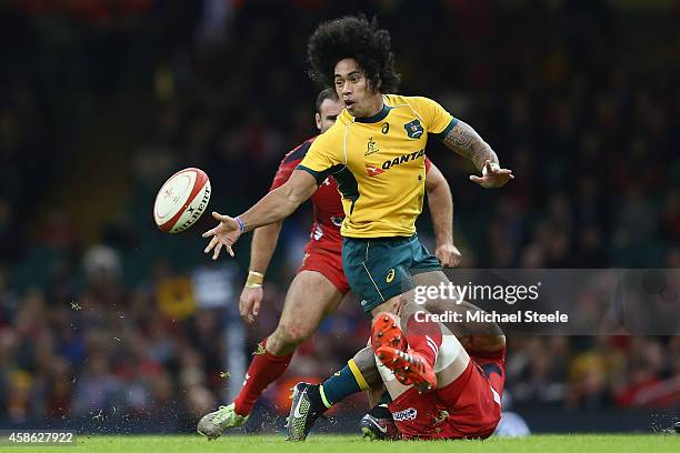 Joe Tomane of Australia offloads as Alun Wyn Jones of Wales holds on in the tackle during the International match between Wales and Australia at the...