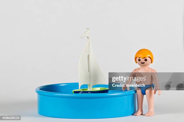 playmobil boy, baby pool and a sailing boat - speedo boy stock pictures, royalty-free photos & images