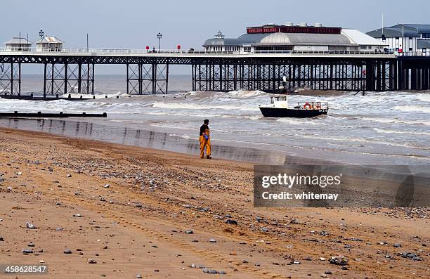 fisherman with boat on cromer beach, norfolk - cromer pier stock pictures, royalty-free photos & images