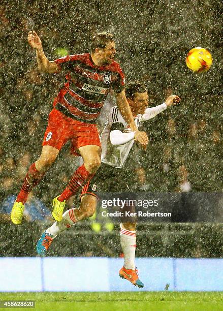 Grant Holt of Huddersfield Town and Scott Parker of Fulham challenge for the ball in the air during the Sky Bet Championship match between Fulham and...