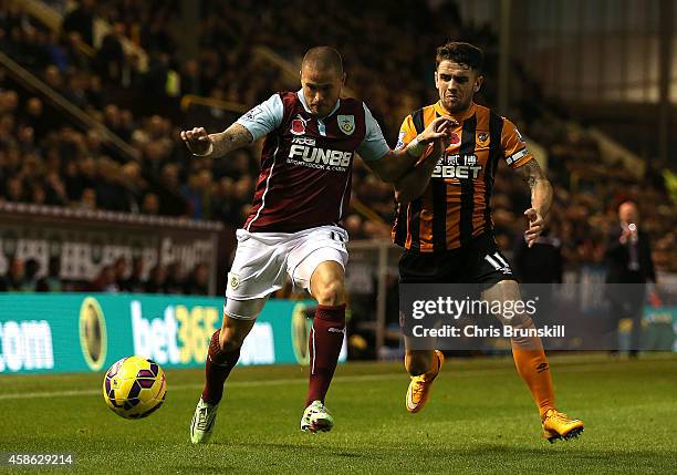 Michael Kightly of Burnley battles with Robbie Brady of Hull City during the Barclays Premier League match between Burnley and Hull City at Turf Moor...