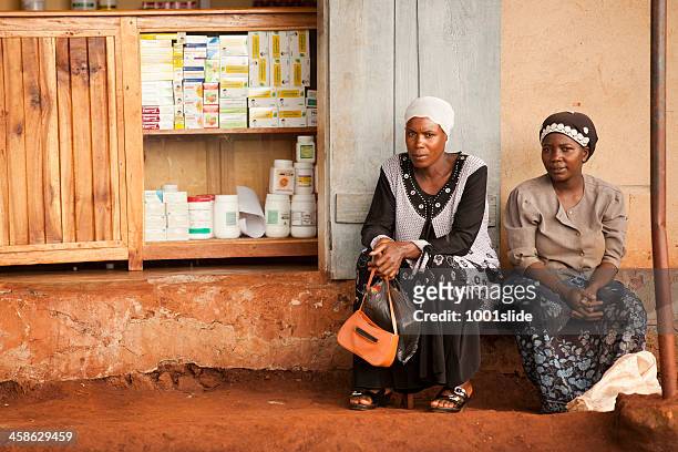 african women are sitting - uganda stock pictures, royalty-free photos & images