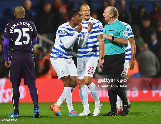 Leroy Fer , Bobby Zamora and Karl Henry of QPR protest to referee Mike Dean as Charlie Austin's goal is disallowed during the Barclays Premier League...