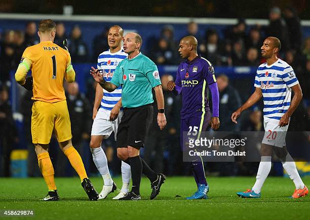 Referee Mike Dean talks to Joe Hart of Manchester City as Charlie Austin's goal is disallowed during the Barclays Premier League match between Queens...
