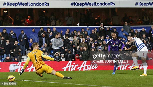 Queens Park Rangers' English striker Charlie Austin shoots to score the opening goal past Manchester City's English goalkeeper Joe Hart during the...