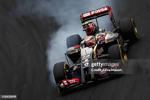 Pastor Maldonado of Venezuela and Lotus locks up during qualifying for the Brazilian Formula One Grand Prix at Autodromo Jose Carlos Pace on November...