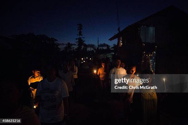 Residents of San Joaquin walk through the towns streets during a dawn candle light procession on November 8, 2014 in Tacloban, Leyte, Philippines....