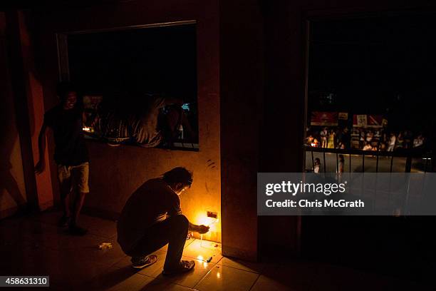 Residents light candles inside the baranguy hall in San Jose during the candlelight memorial on November 8, 2014 in Tacloban, Leyte, Philippines....