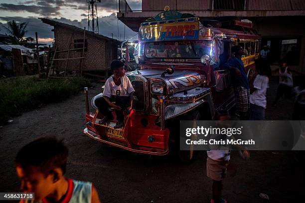 Children play on a Jeepnee as they wait for the candlelight memorial to start on November 8, 2014 in San Jose, Leyte, Philippines. People lined the...