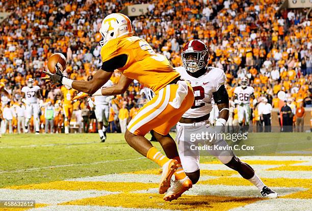 Josh Malone of the Tennessee Volunteers pulls in this touchdown reception against Tony Brown of the Alabama Crimson Tide at Neyland Stadium on...