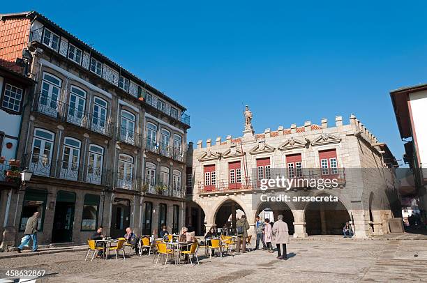 tourists at oliveira square in guimaraes - guimarães stock pictures, royalty-free photos & images