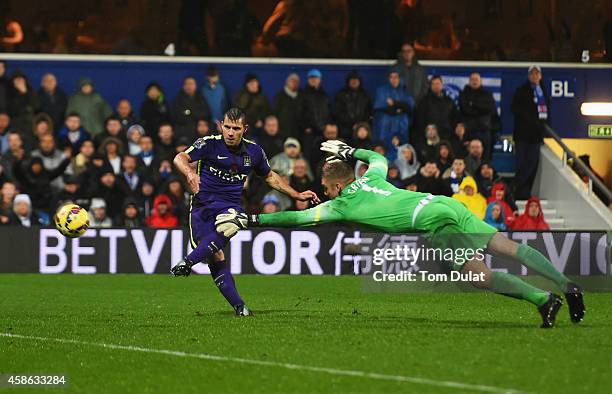 Sergio Aguero of Manchester City beats goalkeeper Robert Green of QPR to score their second goal during the Barclays Premier League match between...