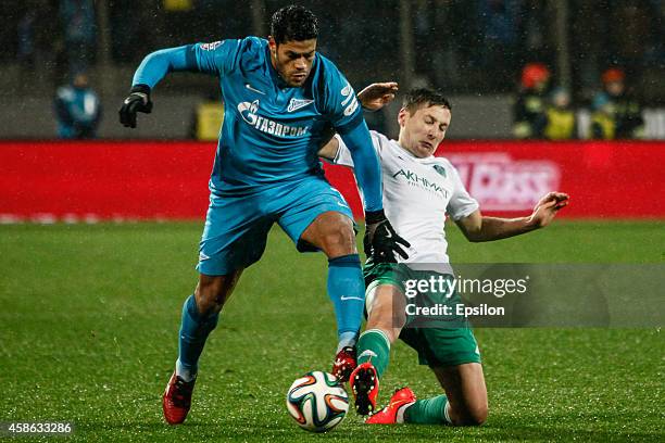 Hulk of FC Zenit St. Petersburg and Daler Kuzyayev of FC Terek Grozny vie for the ball during the Russian Football League Championship match between...