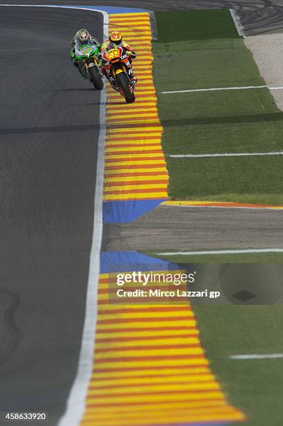 Aleix Espargaro of Spain and NGM Mobile Forward Racing and Nicky Hayden of USA and Drive M7 Aspar head down a straight during the qualifying practice...