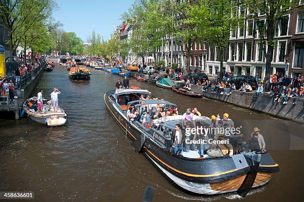 party boats on queen's day (amsterdam, netherlands) - kings day celebration in amsterdam stock pictures, royalty-free photos & images
