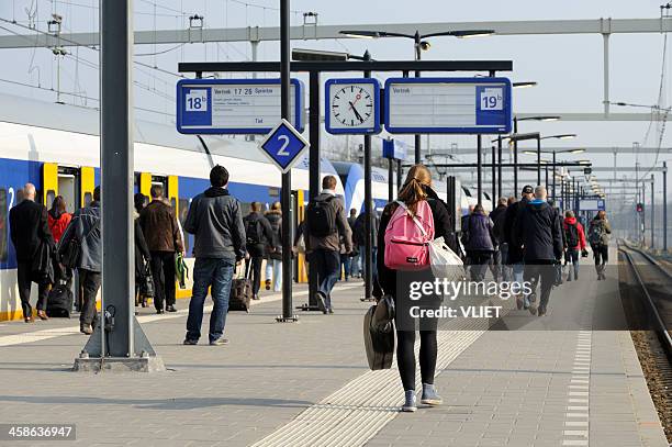 commuters on a platform at utrecht centraal railway station - utrecht stockfoto's en -beelden
