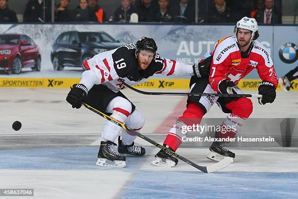 Reto Suri of Switzerland skates with Bobby Raymond of Canada during match 4 of the Deutschland Cup 2014 between Switzerland and Canada at Olympia...