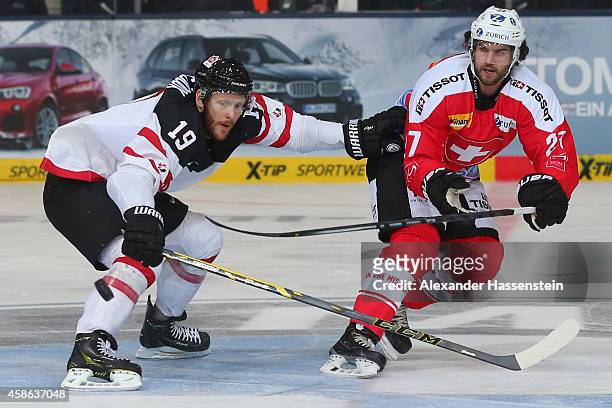 Reto Suri of Switzerland skates with Bobby Raymond of Canada during match 4 of the Deutschland Cup 2014 between Switzerland and Canada at Olympia...