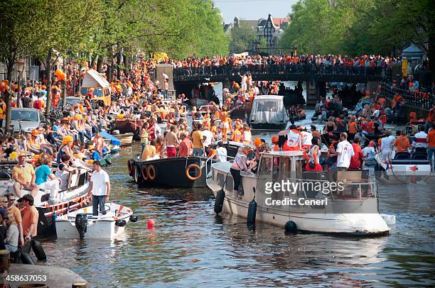 party boats on queen's day (amsterdam, netherlands) - kings day netherlands stock pictures, royalty-free photos & images