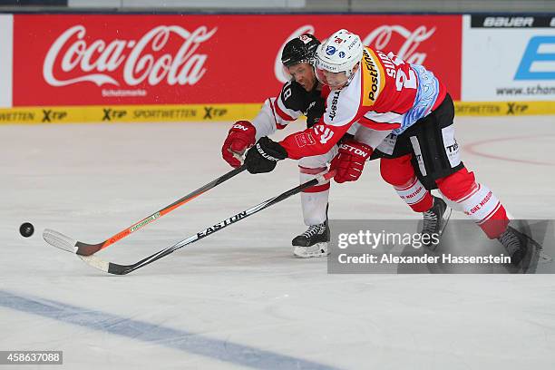 Reto Suri of Switzerland skates with Jared Aulin of Canada during match 4 of the Deutschland Cup 2014 between Switzerland and Canada at Olympia...