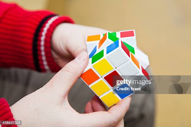 hands playing a cube game - rubiks kub bildbanksfoton och bilder