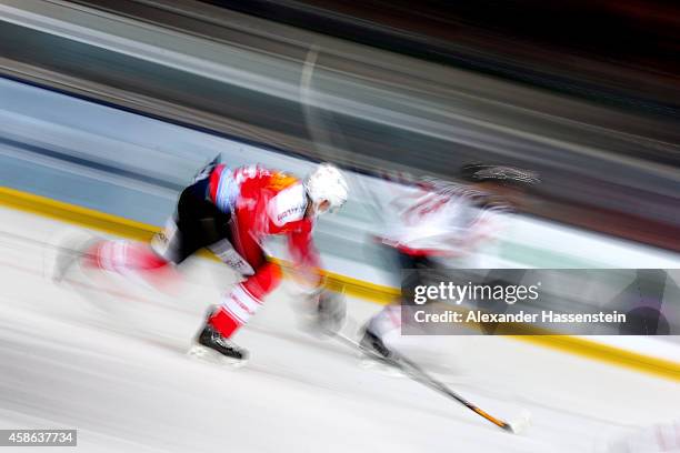 Mike Kuenzle of Switzerland skates with Steven Reinprecht of Canada during match 4 of the Deutschland Cup 2014 between Switzerland and Canada at...