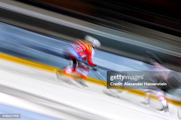 Clarence Kparghai of Switzerland skates with Steven Reinprecht of Canada during match 4 of the Deutschland Cup 2014 between Switzerland and Canada at...