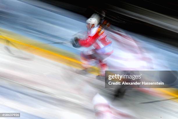 Mike Kuenzle of Switzerland skates with Steven Reinprecht of Canada during match 4 of the Deutschland Cup 2014 between Switzerland and Canada at...