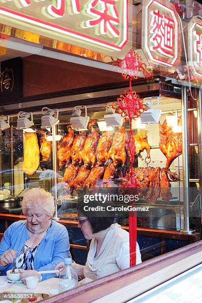women eating in china town restaurant - peking duck in window stock pictures, royalty-free photos & images