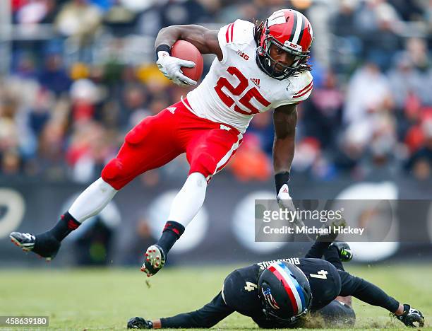 Melvin Gordon of the Wisconsin Badgers runs the ball as Taylor Richards of the Purdue Boilermakers attempts the tackle at Ross-Ade Stadium on...