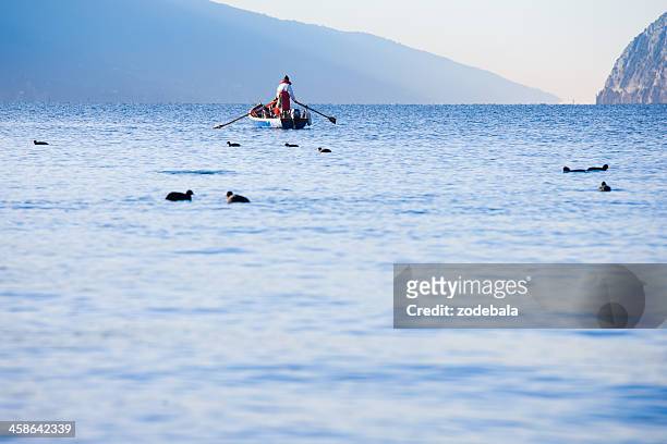 fisherman on lake garda, italy - torbole stock pictures, royalty-free photos & images