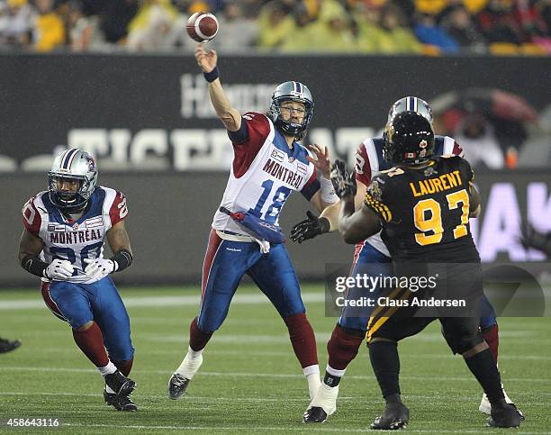 Jonathan Crompton of the Montreal Alouettes fires a pass against the Hamilton Tiger-cats in a CFL football game at Tim Hortons Field on November 8,...