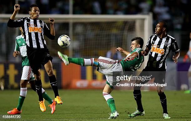 Victor Luis of Palmeiras fights for the ball with Alex Silva and Eduardo of Atletico during the match between Palmeiras and Atletico MG for the...