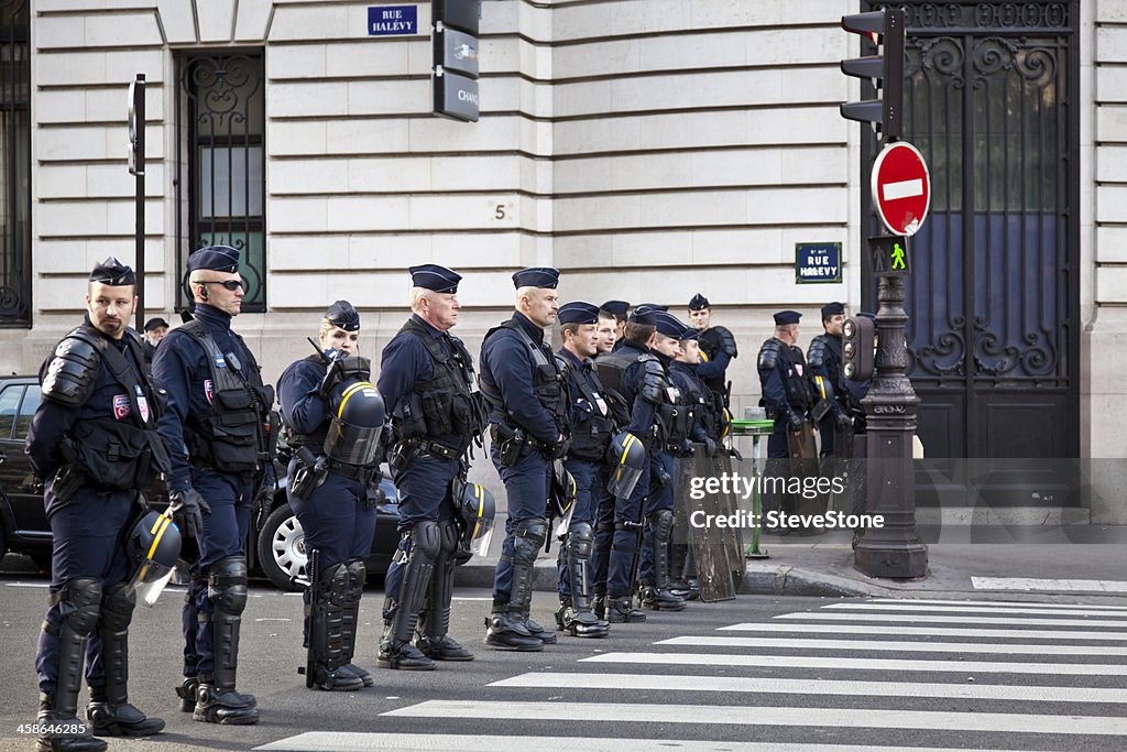 French National Police protect a road crossing during union strikes