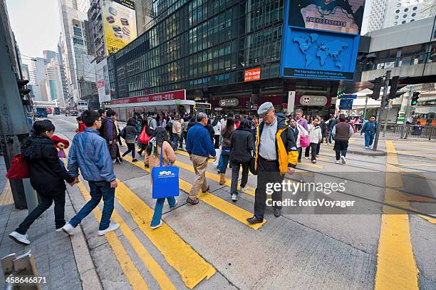 crowd of pedestrians crossing downtown hong kong china - now voyager stock pictures, royalty-free photos & images