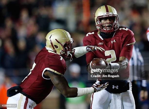 Tyler Murphy of the Boston College Eagles hands the ball to Marcus Outlow against the Louisville Cardinals in the first quarter at Alumni Stadium on...