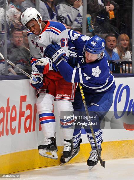 Morgan Rielly of the Toronto Maple Leafs battles with Anthony Duclair of the New York Rangers during NHL game action November 8, 2014 at the Air...