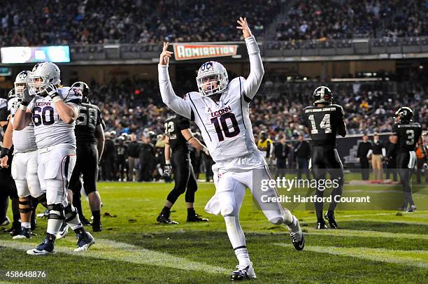 UConn quarterback Chandler Whitmer celebrates his two-yard touchdown run in the final minute of the first half on Saturday, Nov. 8 at Yankee Stadium...