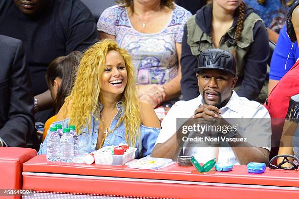 Liza Hernandez and Floyd Mayweather Jr attend a basketball game between the Portland Trail Blazers and the Los Angeles Clippers at Staples Center on...