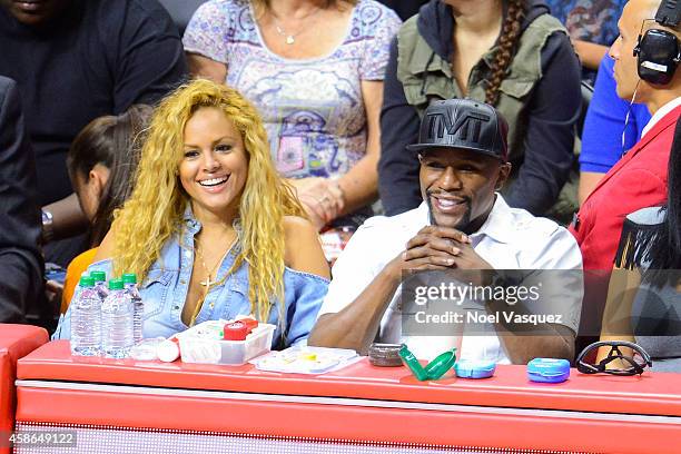 Liza Hernandez and Floyd Mayweather Jr attend a basketball game between the Portland Trail Blazers and the Los Angeles Clippers at Staples Center on...