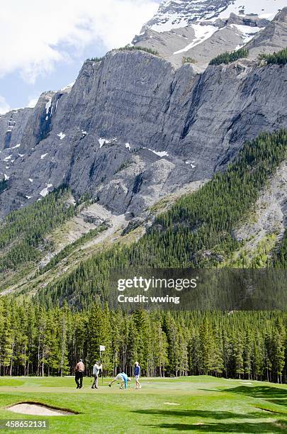 banff golf course and golfers ... on the green - banff springs golf course stock pictures, royalty-free photos & images