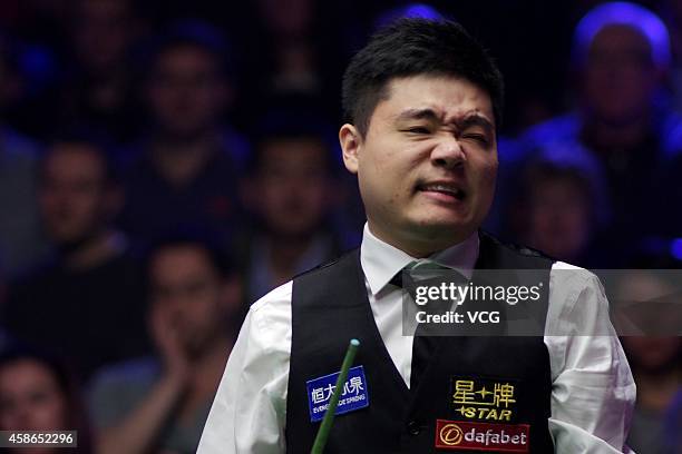Ding Junhui of China reacts against Ronnie O'Sullivan of England on day five of the 2014 Dafabet Champion of Champions at The Ricoh Arena on November...