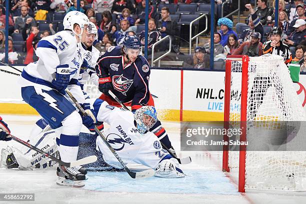 Goaltender Evgeni Nabokov of the Tampa Bay Lightning looks back as a shot from Ryan Johansen of the Columbus Blue Jackets trickles into the net in...