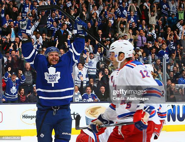 Leo Komarov of the Toronto Maple Leafs celebrates his game-winning goal against Lee Stempniak of the New York Rangers during NHL action at the Air...