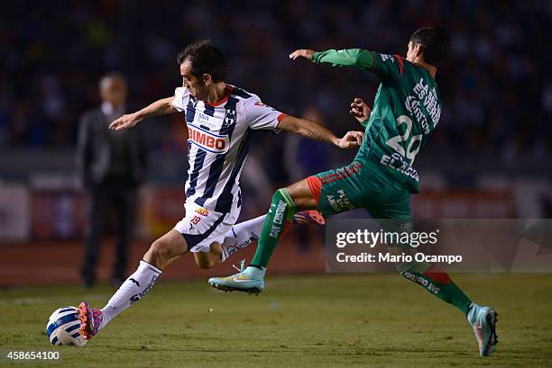 Cesar 'Chelito' Delgado of Monterrey fights for the ball with Julio Nava of Chiapas during a match between Monterrey and Chiapas as part of 16th...