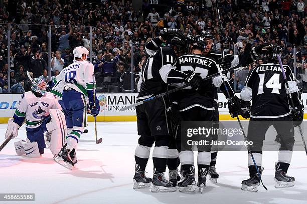 Anze Kopitar, Jake Muzzin, Alec Martinez and Justin Williams of the Los Angeles Kings celebrate a goal during a game against the Vancouver Canucks at...