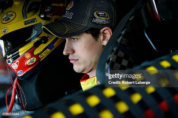 Joey Logano, driver of the Shell-Pennzoil Ford, sits in his car during practice for the NASCAR Sprint Cup Series Goody's Headache Relief Shot 500 at...