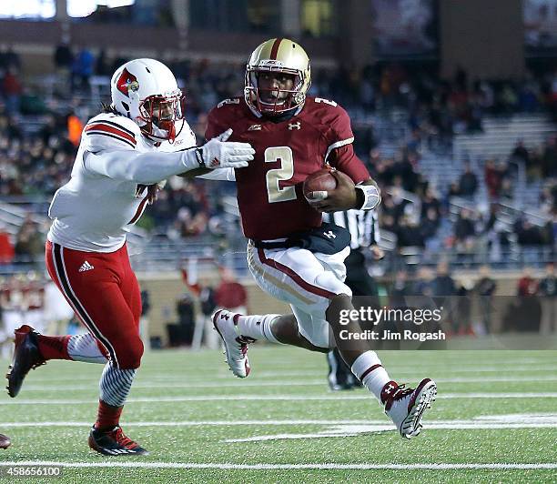 Tyler Murphy of the Boston College Eagles is stopped by Keith Brown of the Louisville Cardinals in the fourth quarter at Alumni Stadium on November...